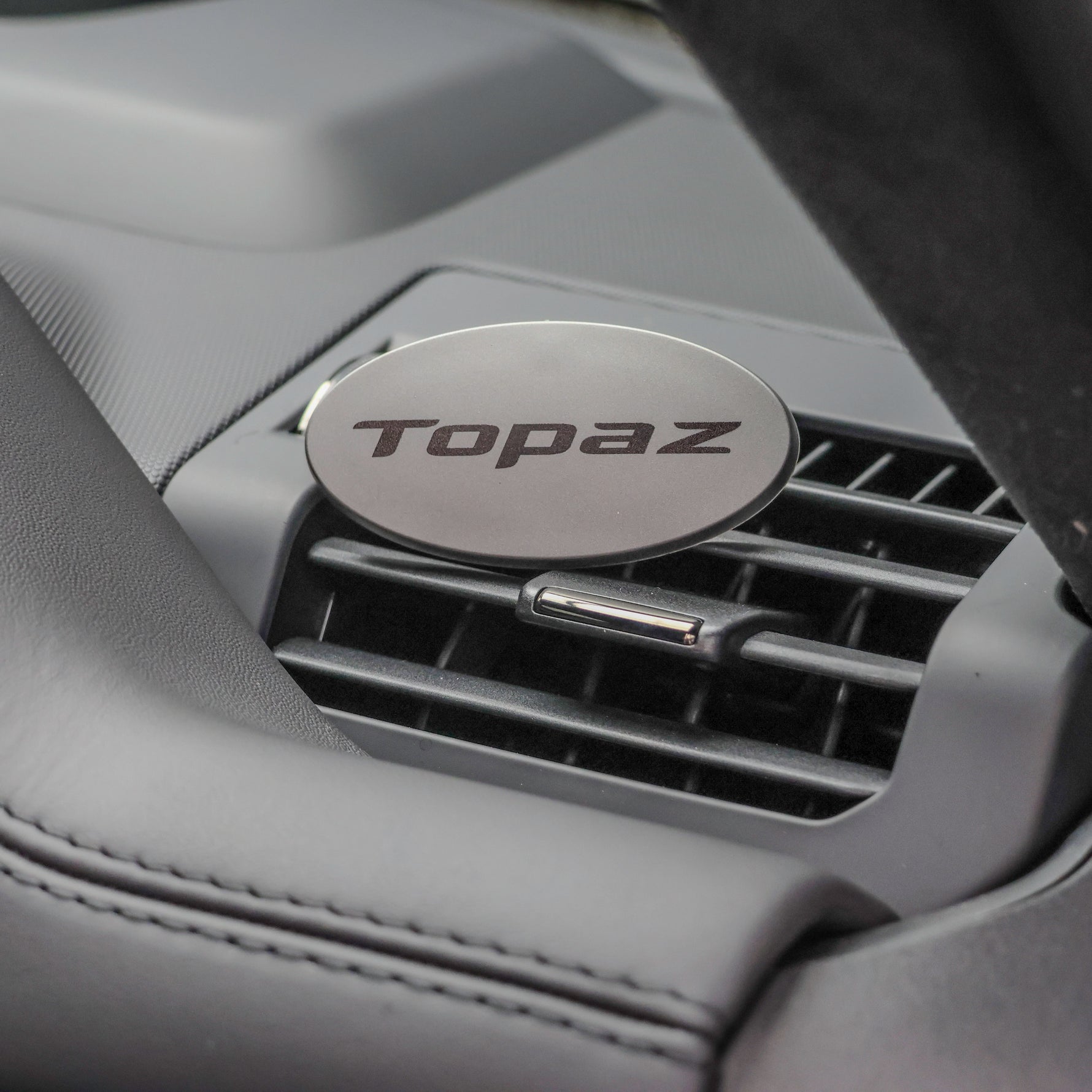 Topaz Oval Clip air freshener clipped on a car vent