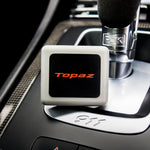 Topaz Square Classic Black Smoke Oud air freshener clipped on a car vent