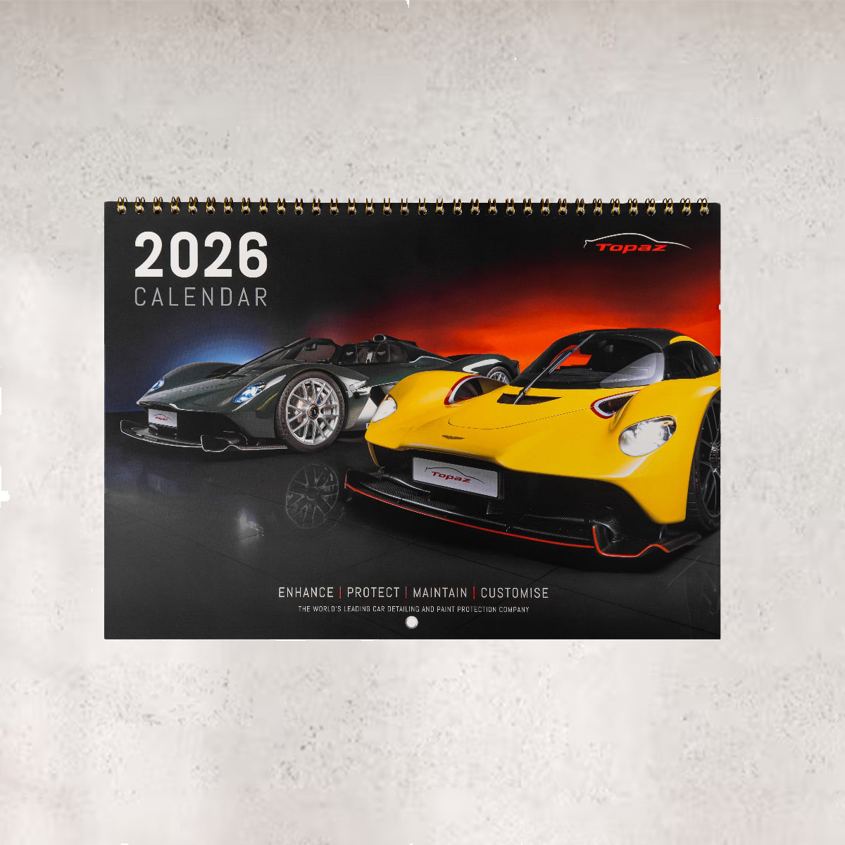 2026 calendar with two sports cars on a gray background